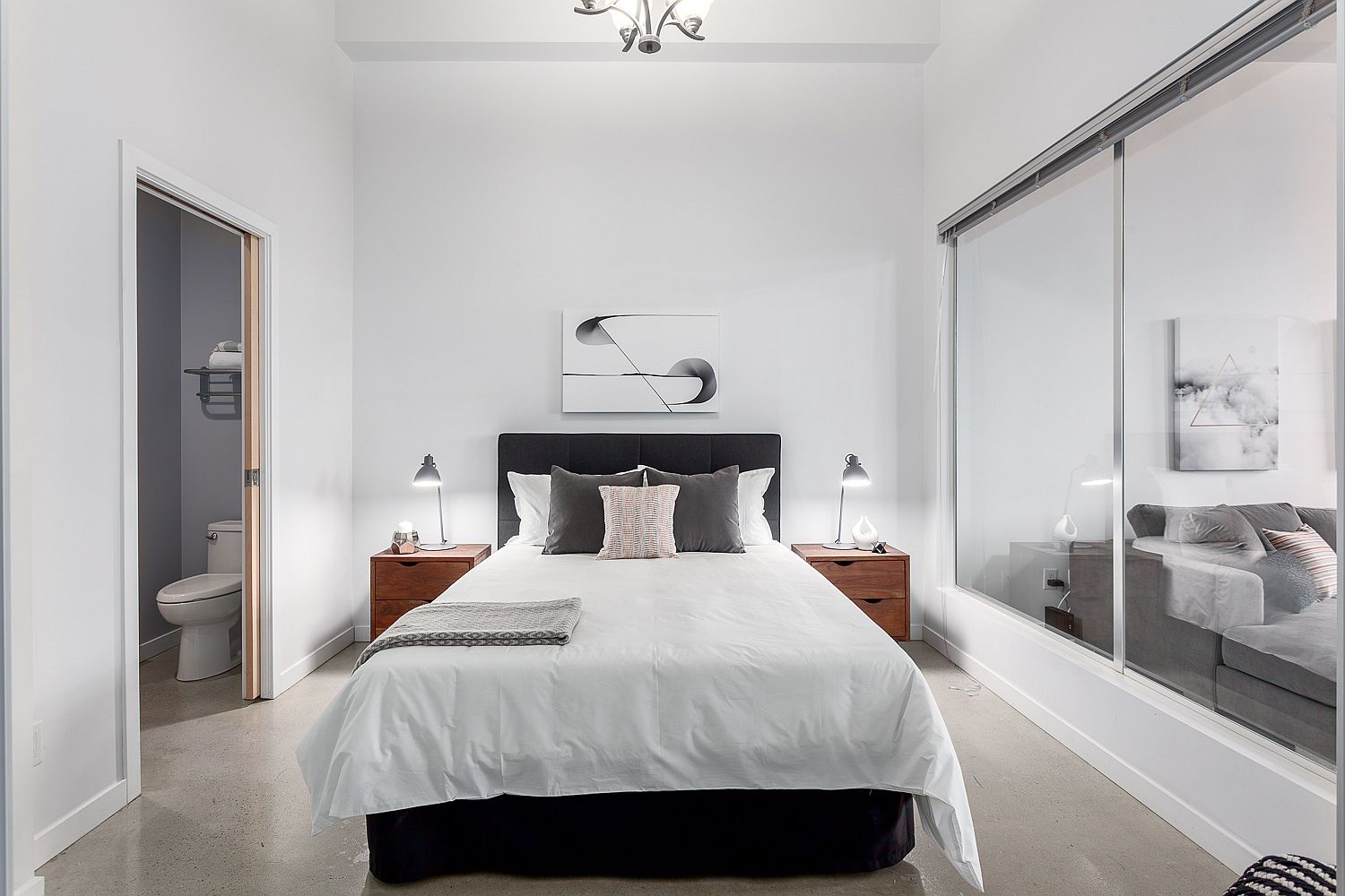 Modern bedroom in white with sliding glass windows and doors