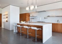 Modern-kitchen-in-wood-and-white-with-slim-bar-stools-and-floating-glass-shelves-217x155
