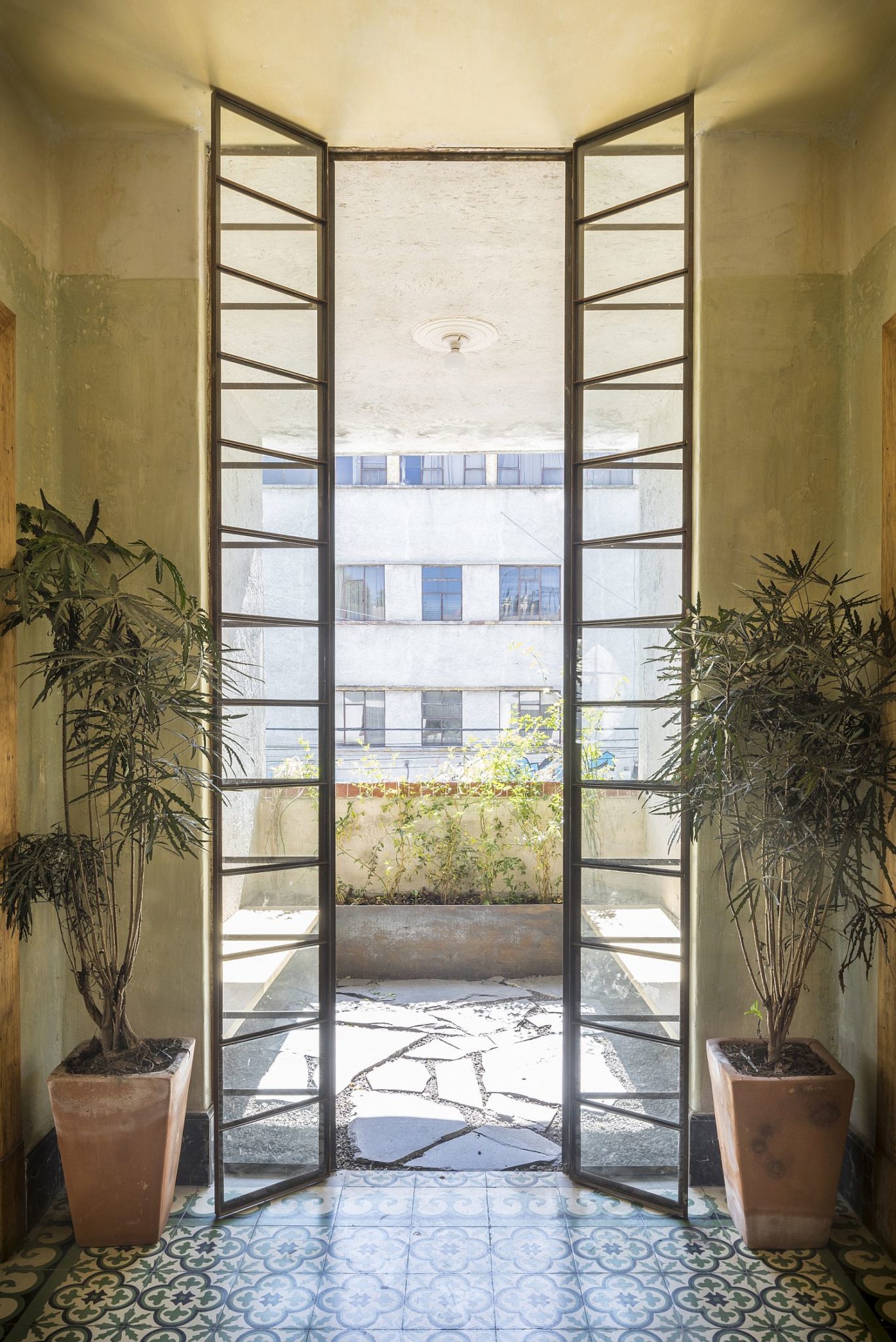 New interior of the restore home flows into the lovely courtyards outside