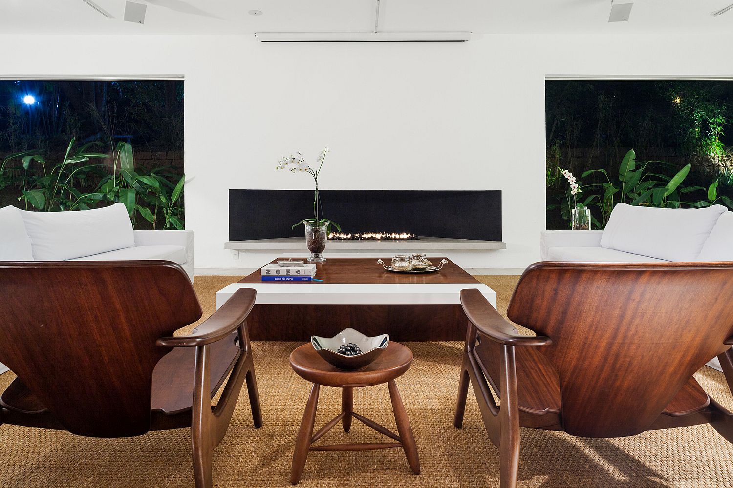 Open and inviting living area in white with a slim, contemporary fireplace