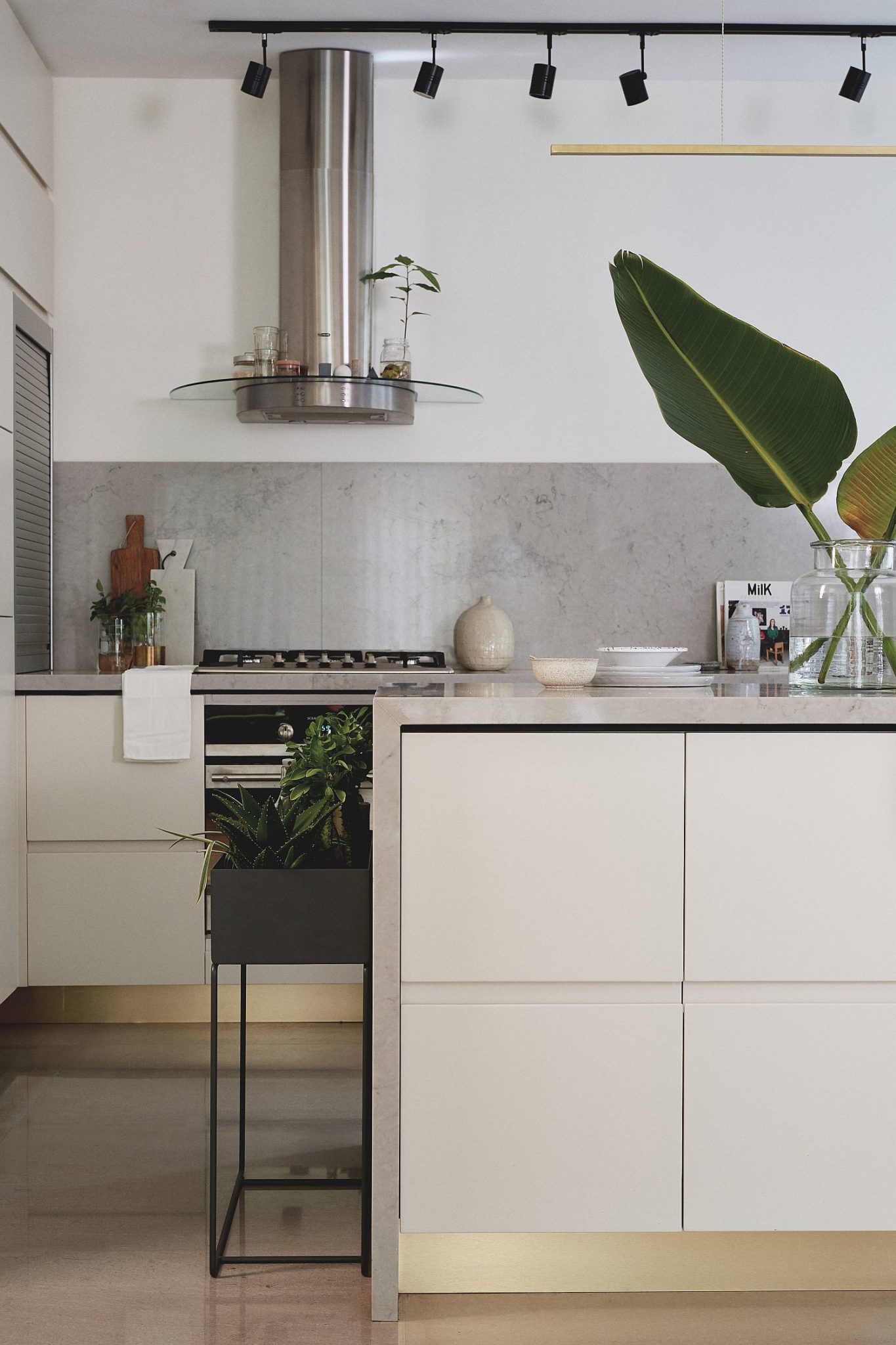 Polished edges of the kitchen with metal shelves and surfaces