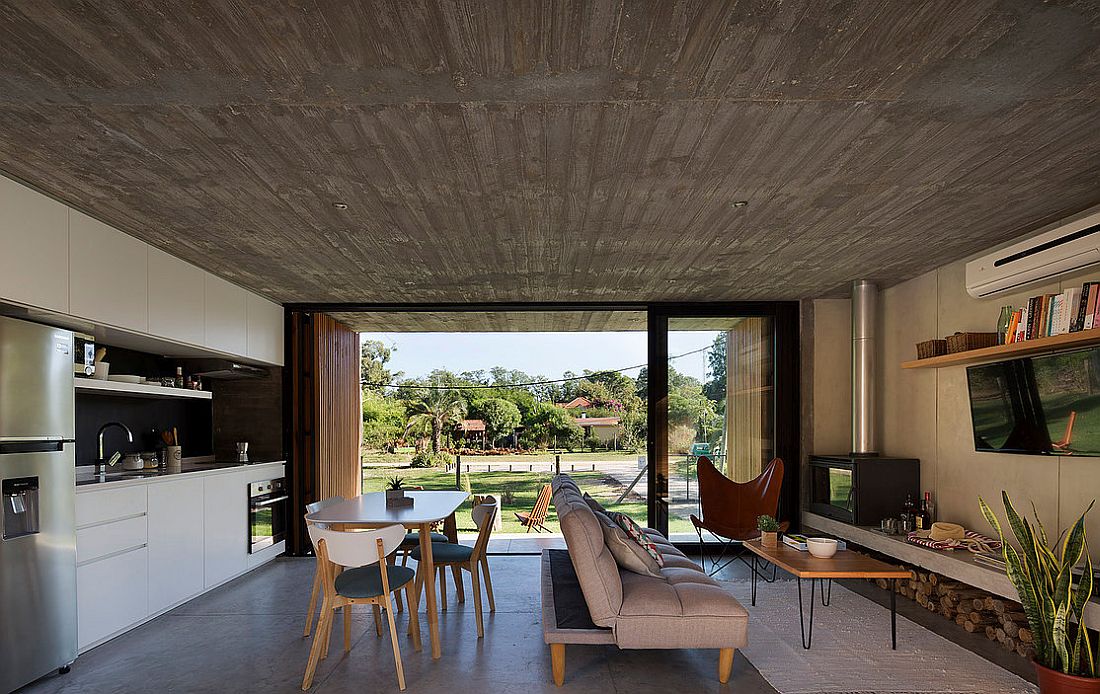 Refined modern finishes are combined with rough exposed concrete inside the house