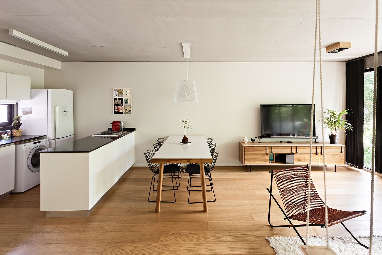 Refined open plan living area with kitchen in the corner