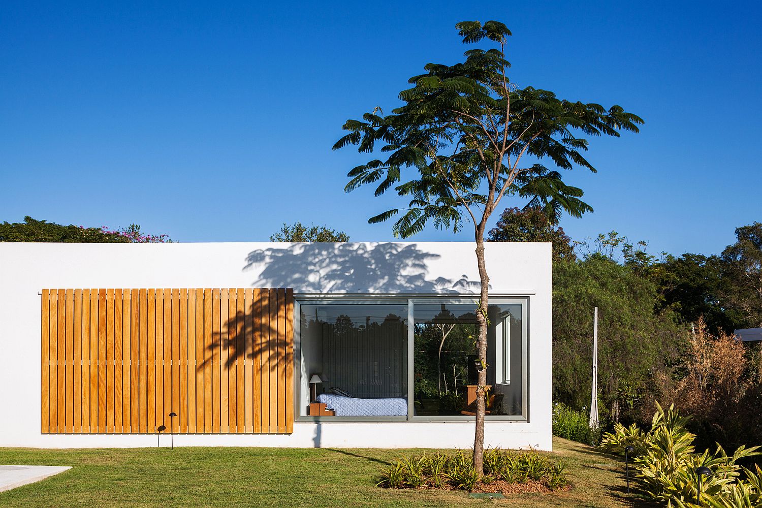 Sliding window made up of wooden slats offers privacy when needed