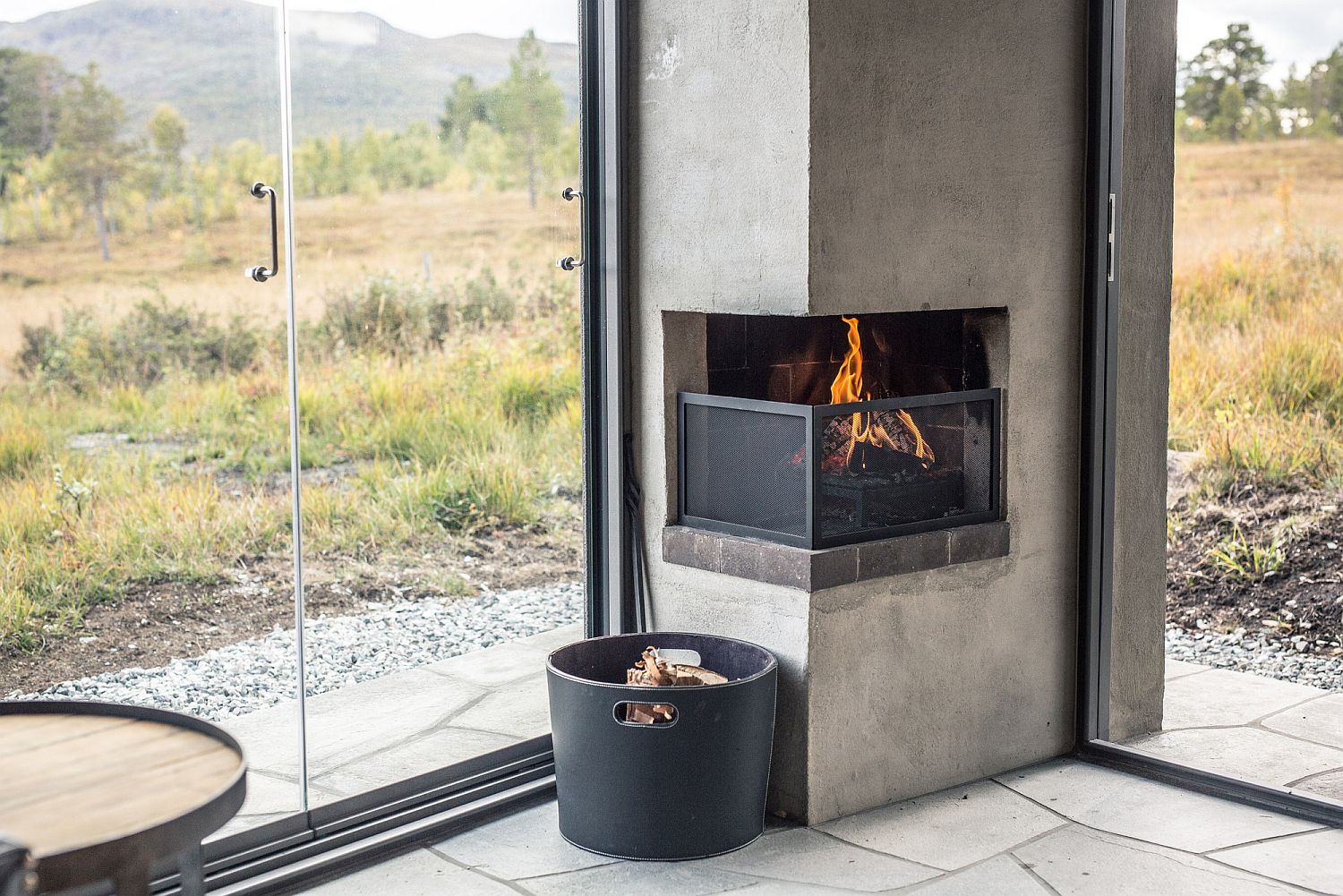 Small corner fireplace is built into the structure of the cabin