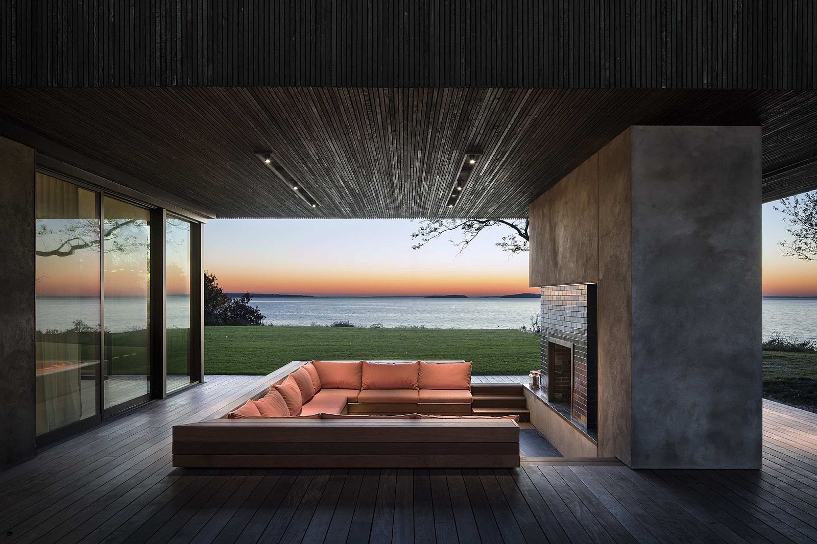 Stunning-outdoor-deck-with-sunken-lounge-and-concrete-fireplace