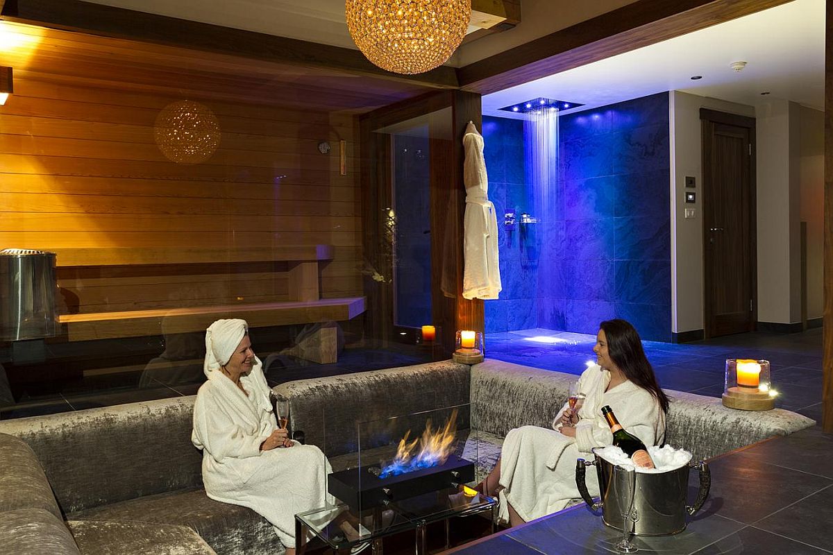 Sunken lounge inside the spa with a modern fireplace at its heart
