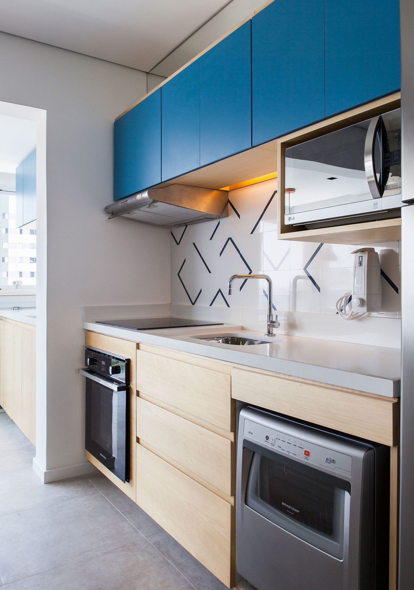 Tiny kitchen with bright blue top cabinets