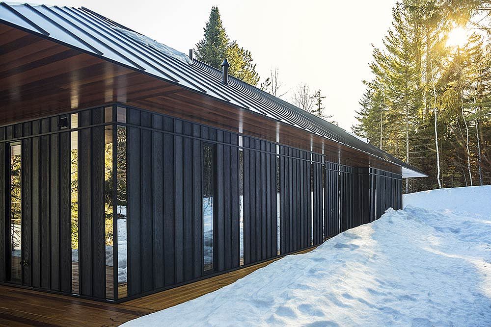 Wooden siding polished steel and glass panels along with the metallic roof make a big impression