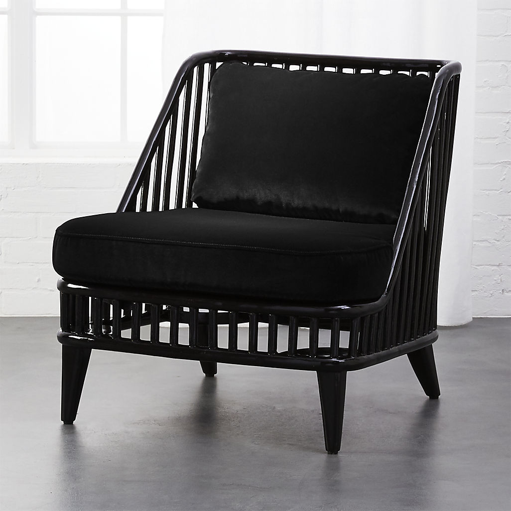 Black rattan chair with velvet cushions