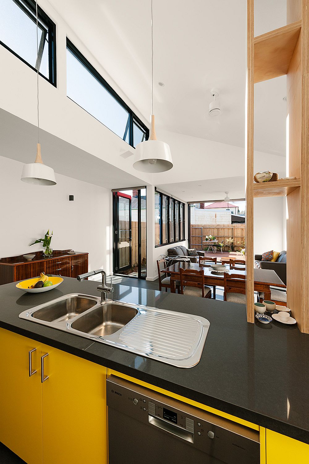 Clerestory windows bring ample natural light into the new kitchen and living area