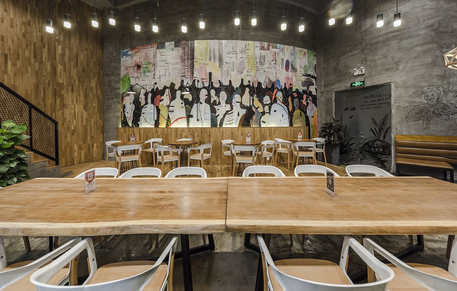 Colorful wall mural and edgy wooden tables inside the Original Bakery