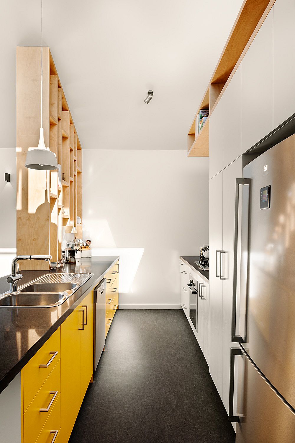 Custom wooden shelf separates the living area from the kitchen