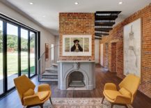 Exposed-brick-walls-and-a-spiral-stairway-shape-the-new-interior-217x155