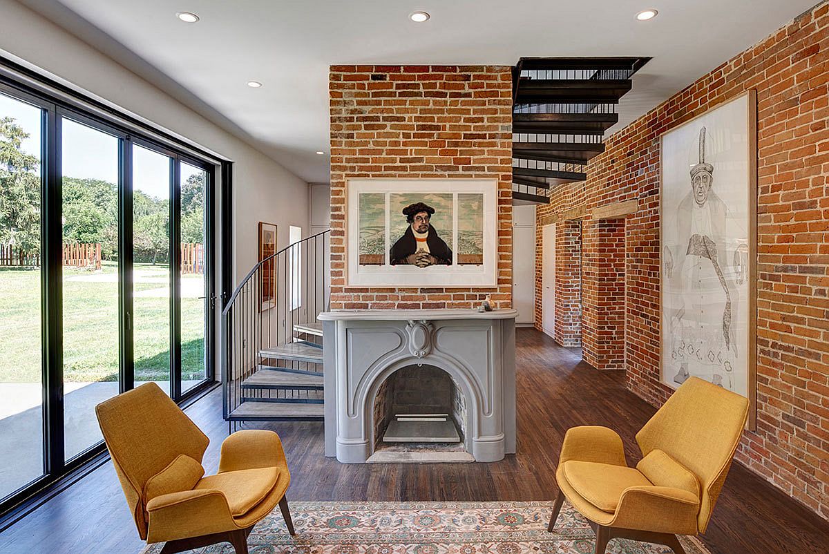 Exposed-brick-walls-and-a-spiral-stairway-shape-the-new-interior