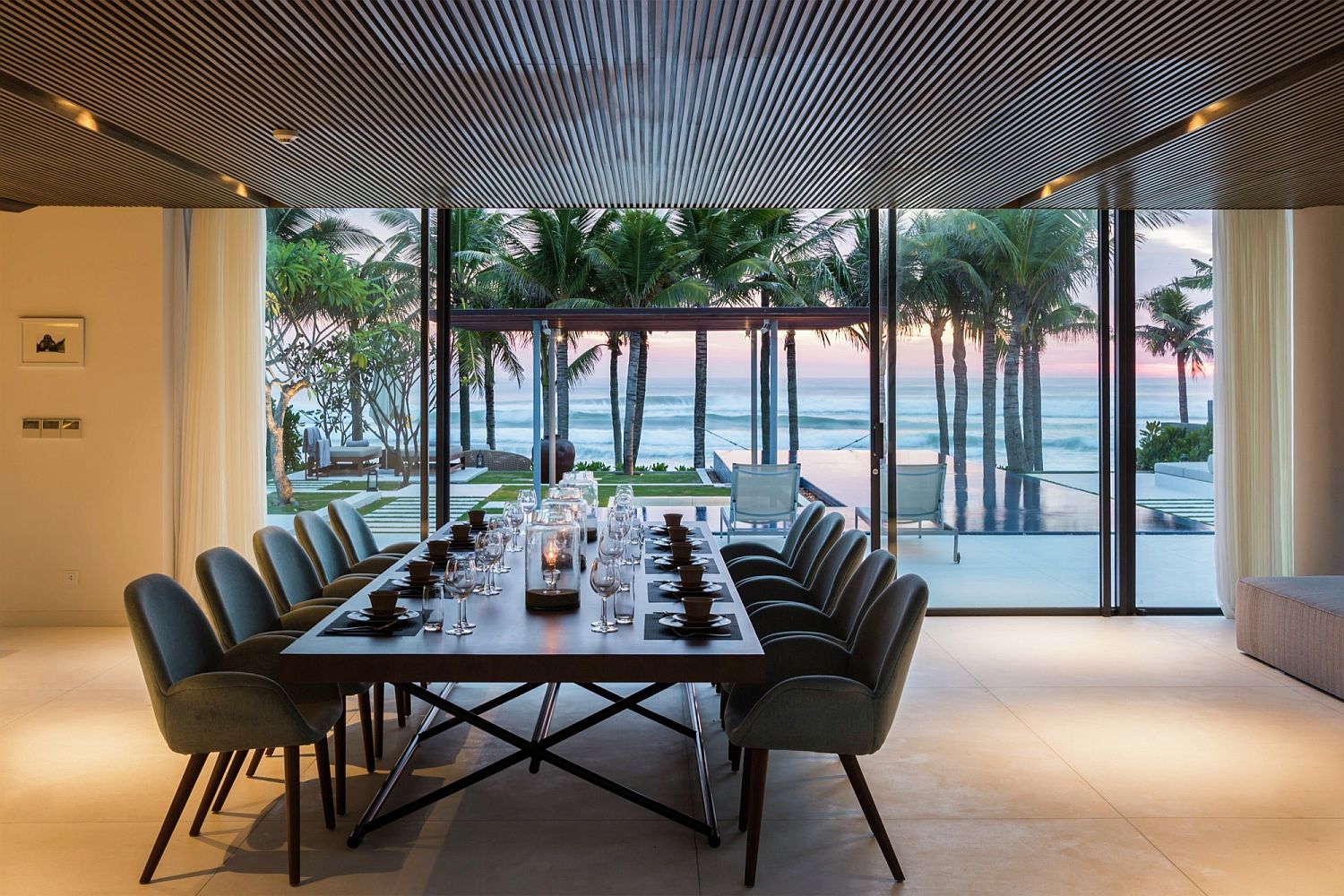 Exquisite dining room with a view of the sea and pool and deck outside