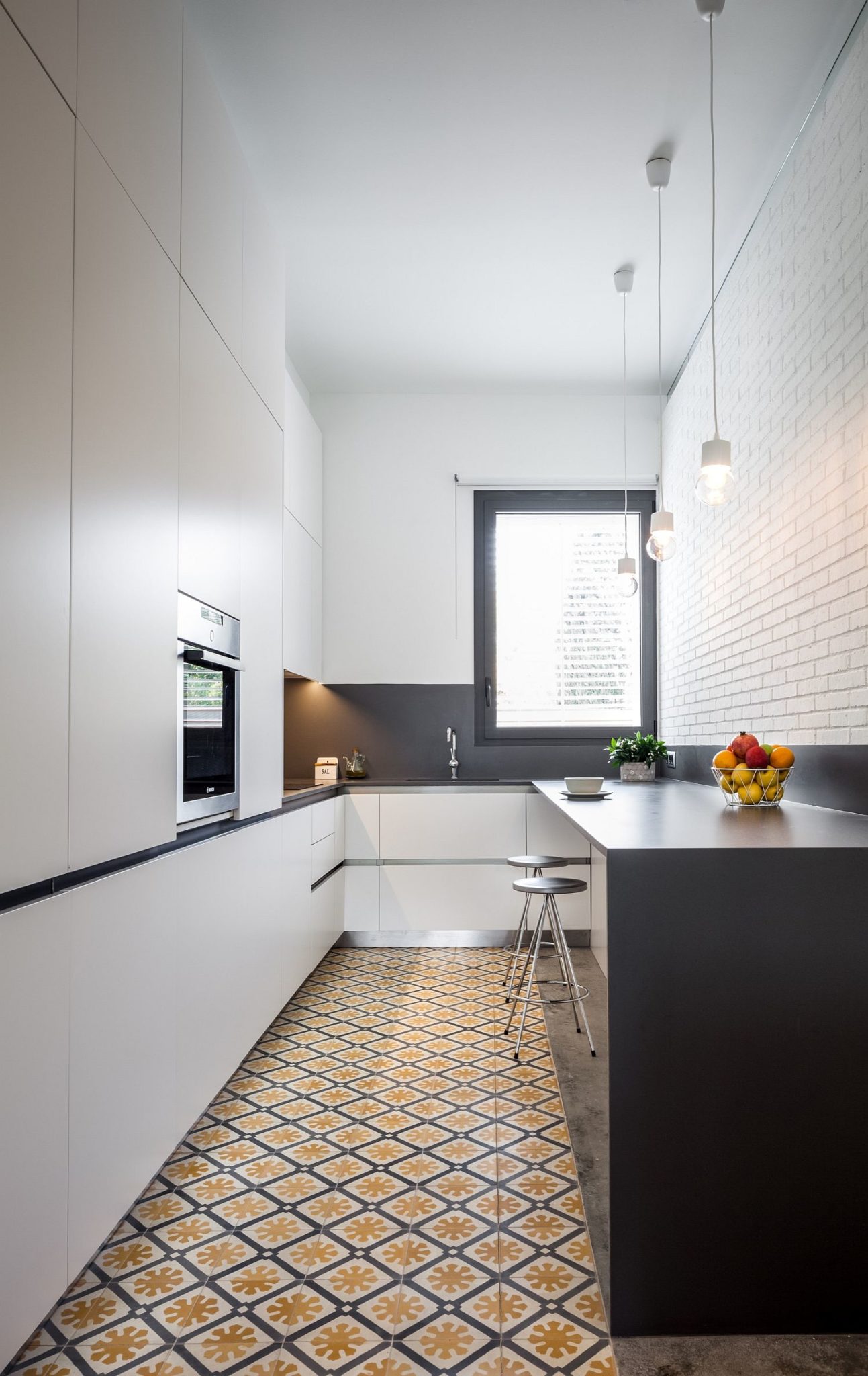 Floor tiles bring color and pattern to contemporary kitchen in white