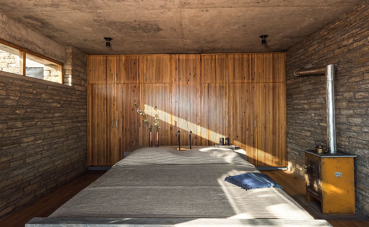 Fly ash bricks and bamboo create a rustic environment inside the bedroom