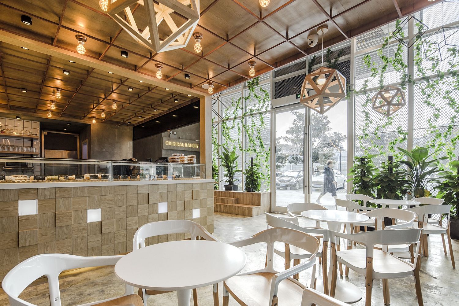 Geometric-pendant-lights-and-gorgeous-greenery-give-the-restaurant-a-unique-look