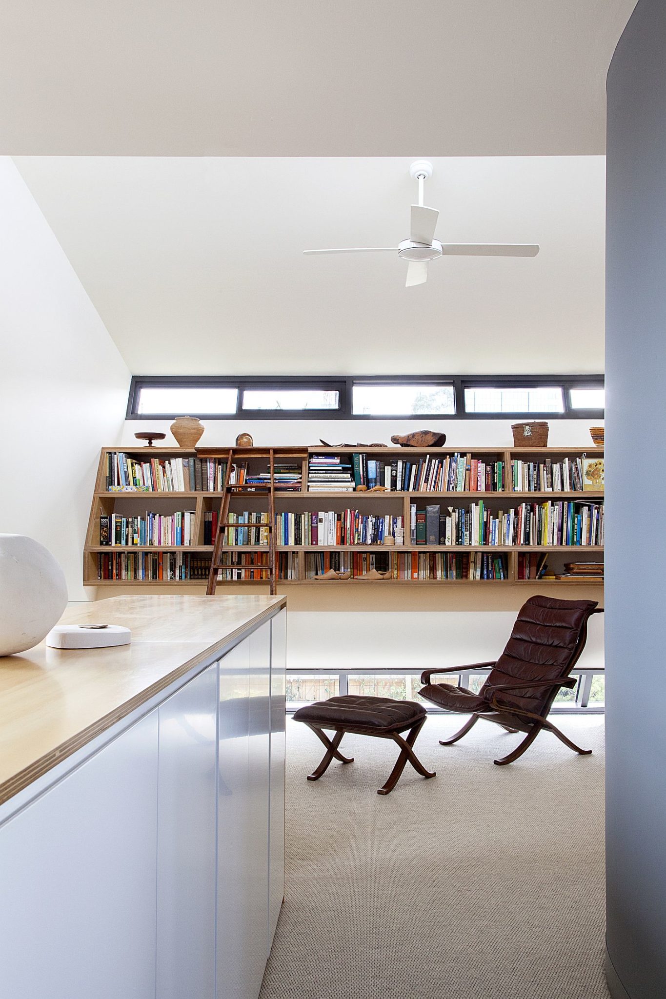 Home office in white with ample shelf space for books