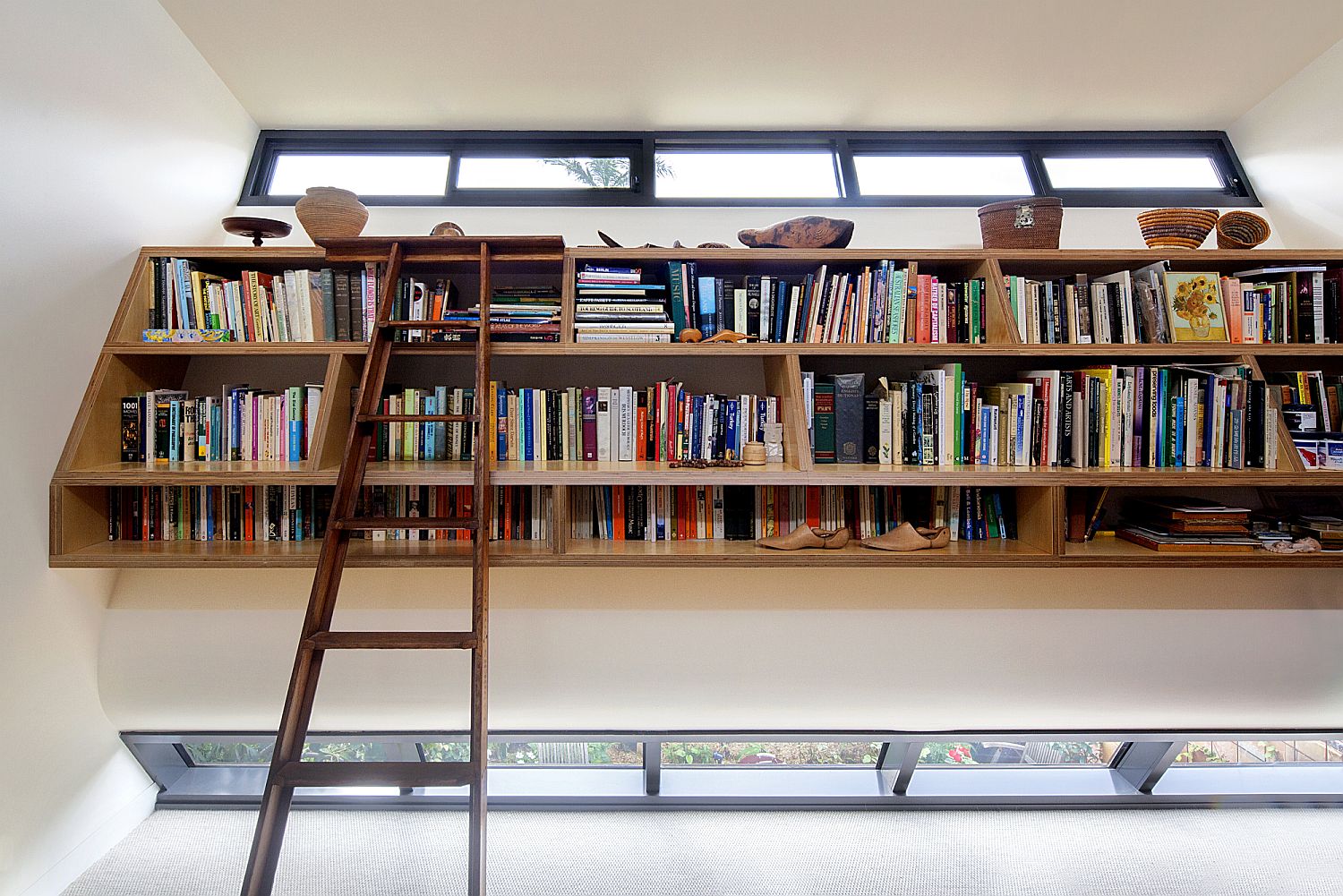 Ladder gives access to the top shelves of the home library