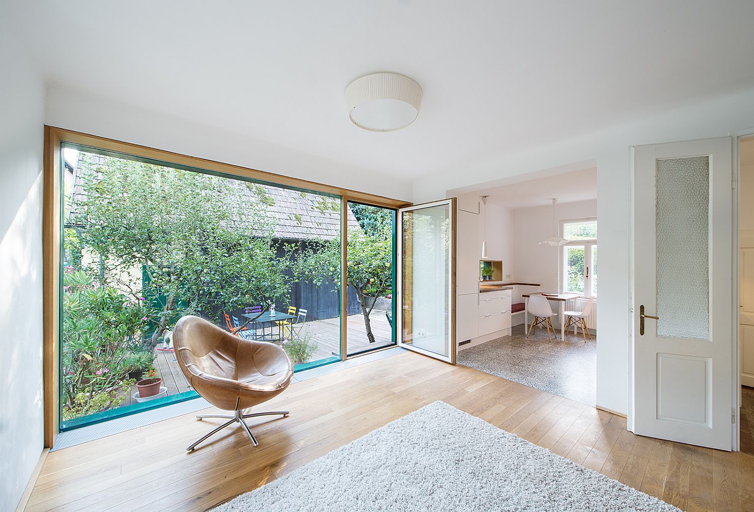 Large glass wall replaces the old walls to bring in natural light