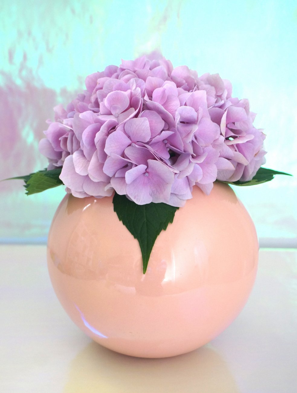 Lavender hydrangea in a peach vase