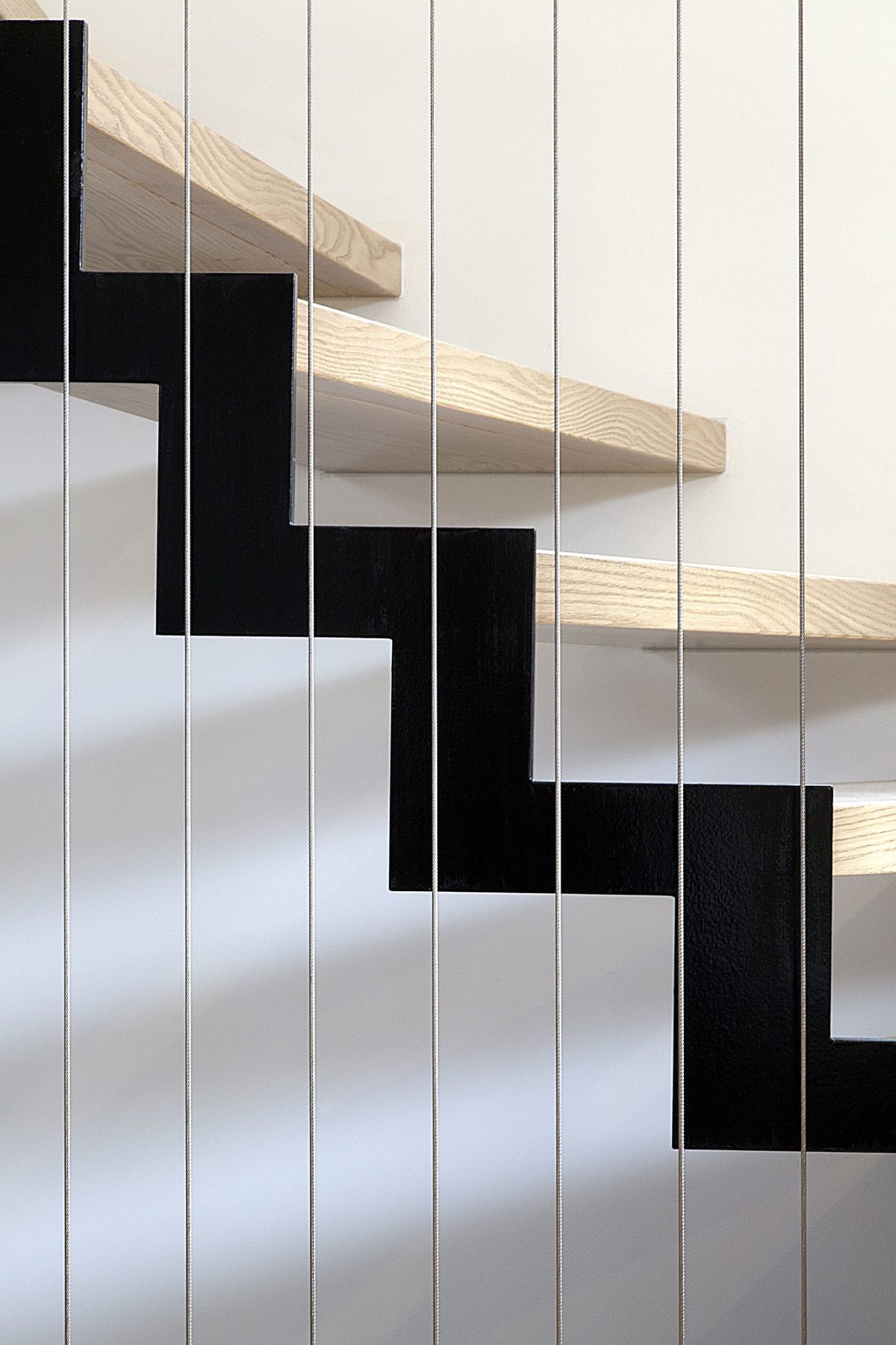 Simple and minimal stairwya connects the two levels of the house