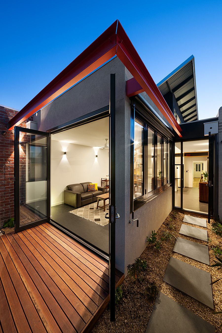 Small rear garden with wooden deck and stone walkway