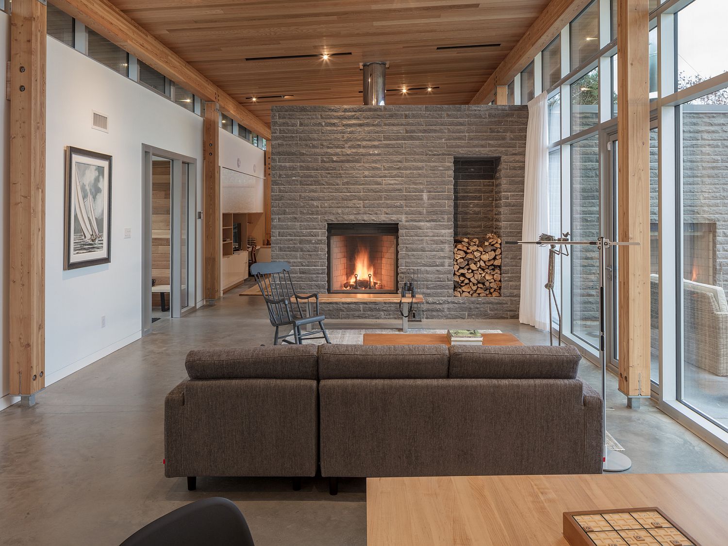 Stone fireplace becomes the focal point of the stunning living room with ocean views