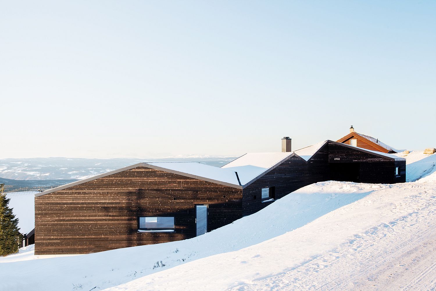 White roof and dark exterior of the cabin present a picture of contrast