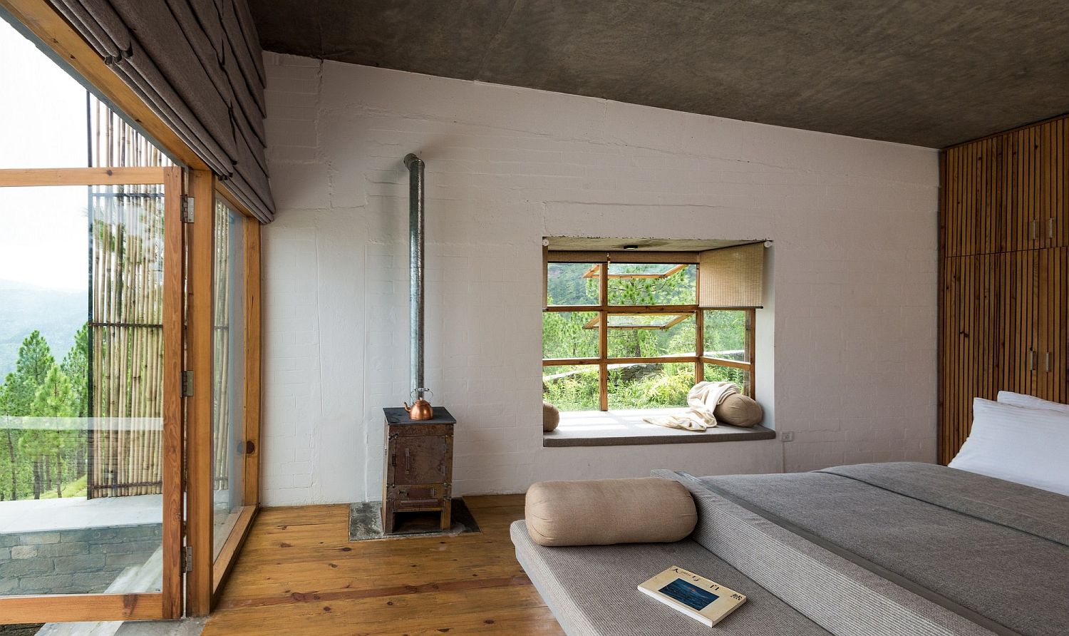 Wood, rustic finsihes and bamboo give the bedroom of the Himalayan hotel a cozy appeal