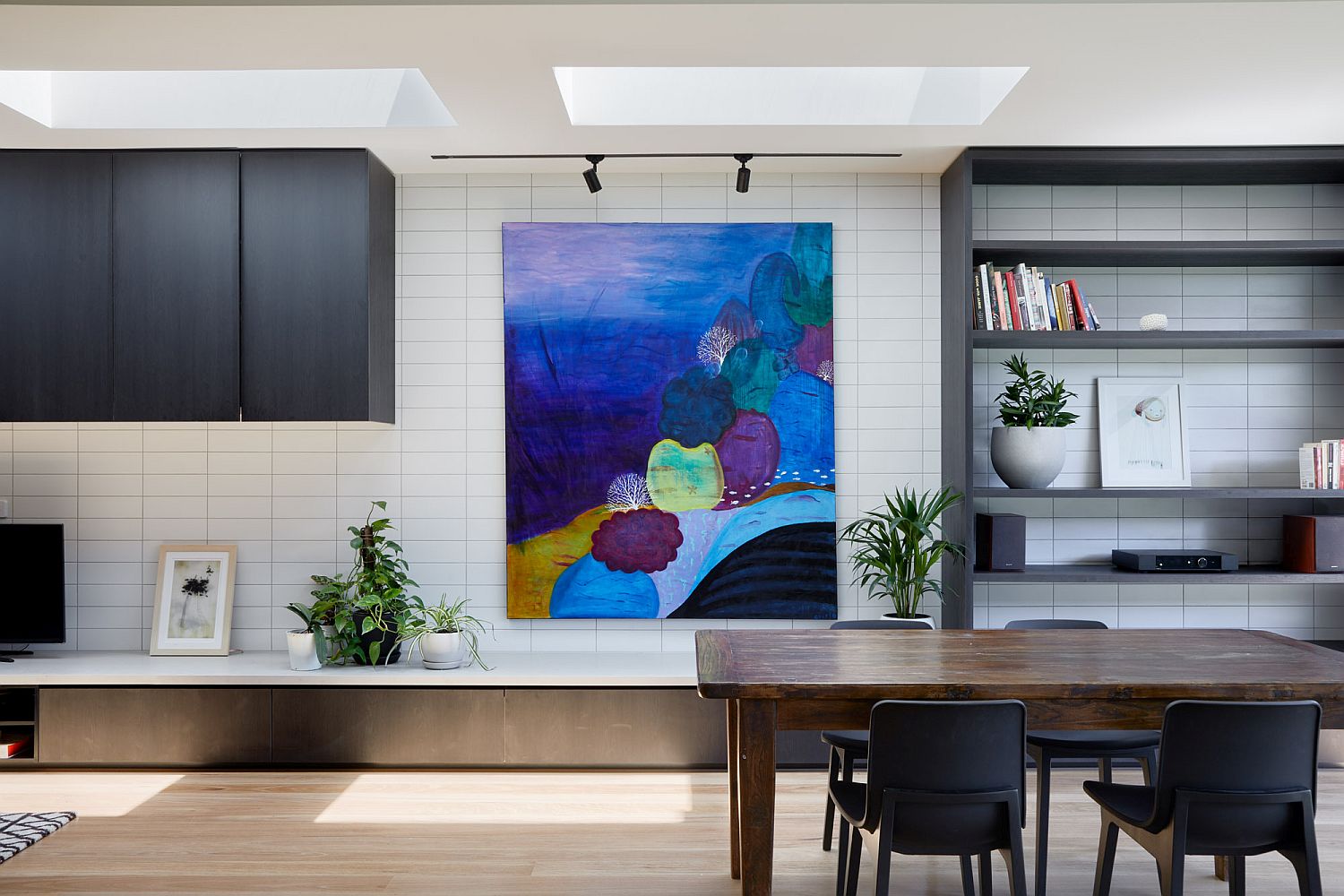 Bright wall art brings color to the neutral interior