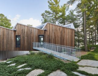 Lakeside Sky House with Reflective Metal Roof and a Cantilevered Volume