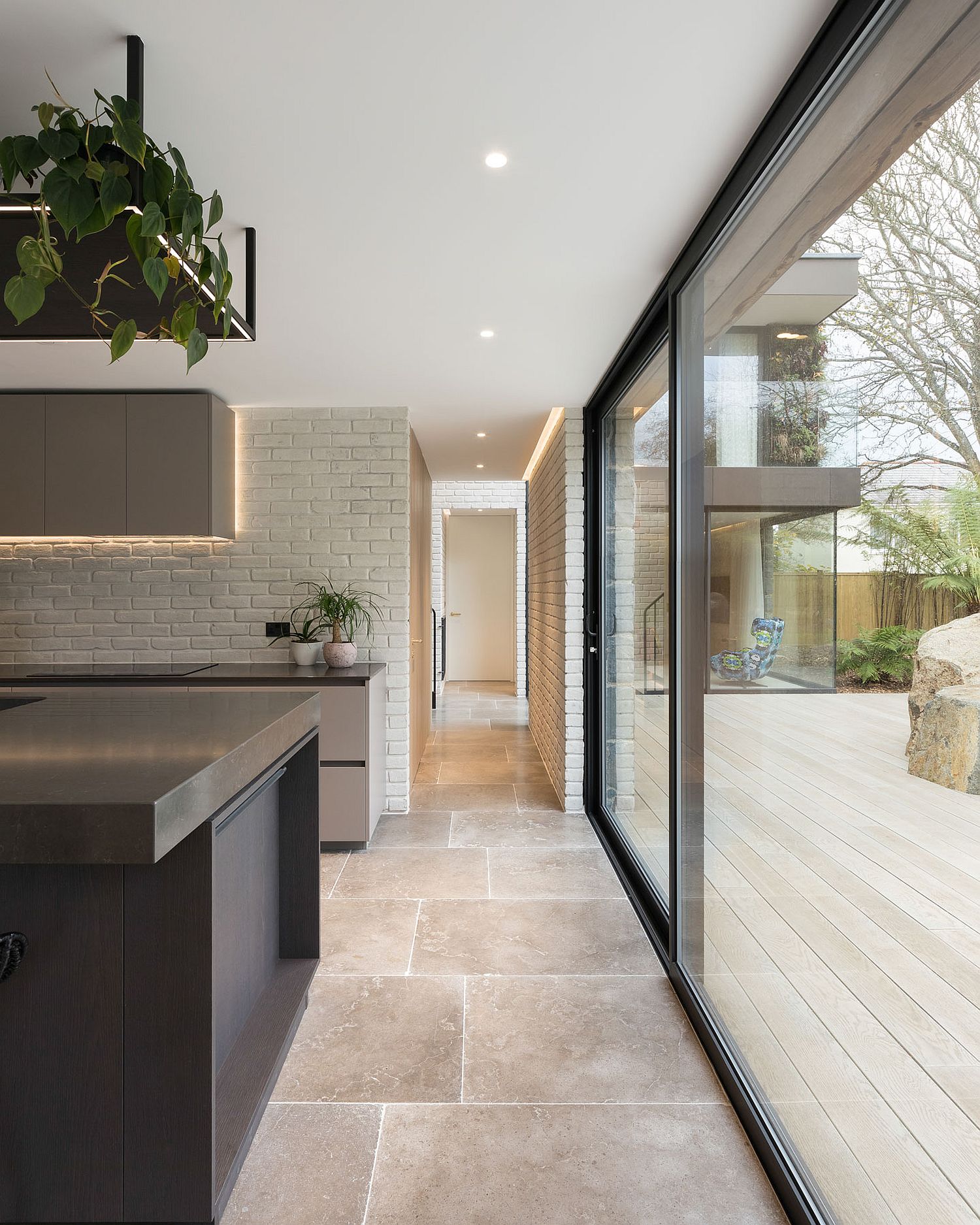 Floor to ceiling glass windows and walls brin in ample natural light