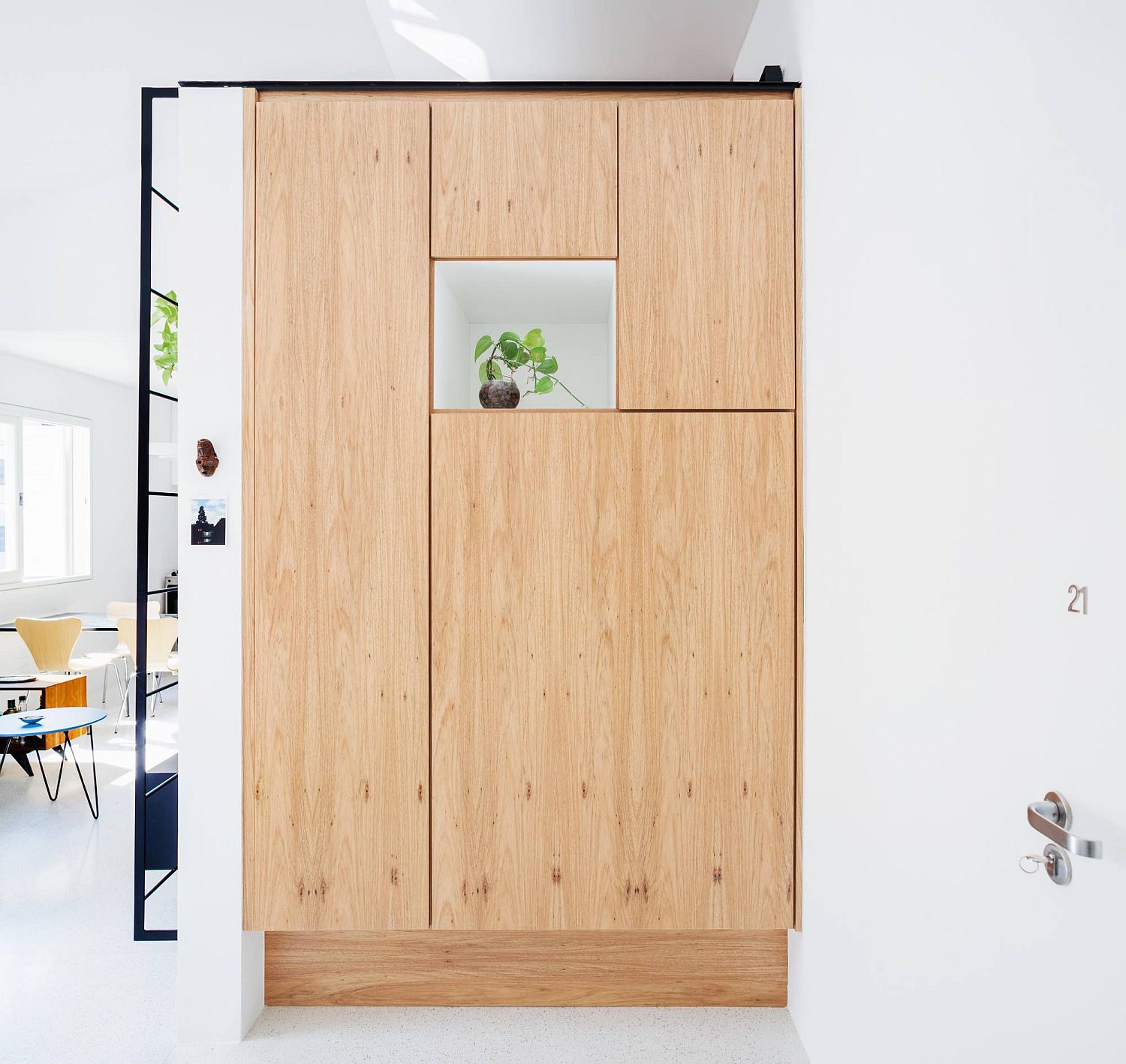 Giant wooden pantry that is neatly tucked behind wooden doors