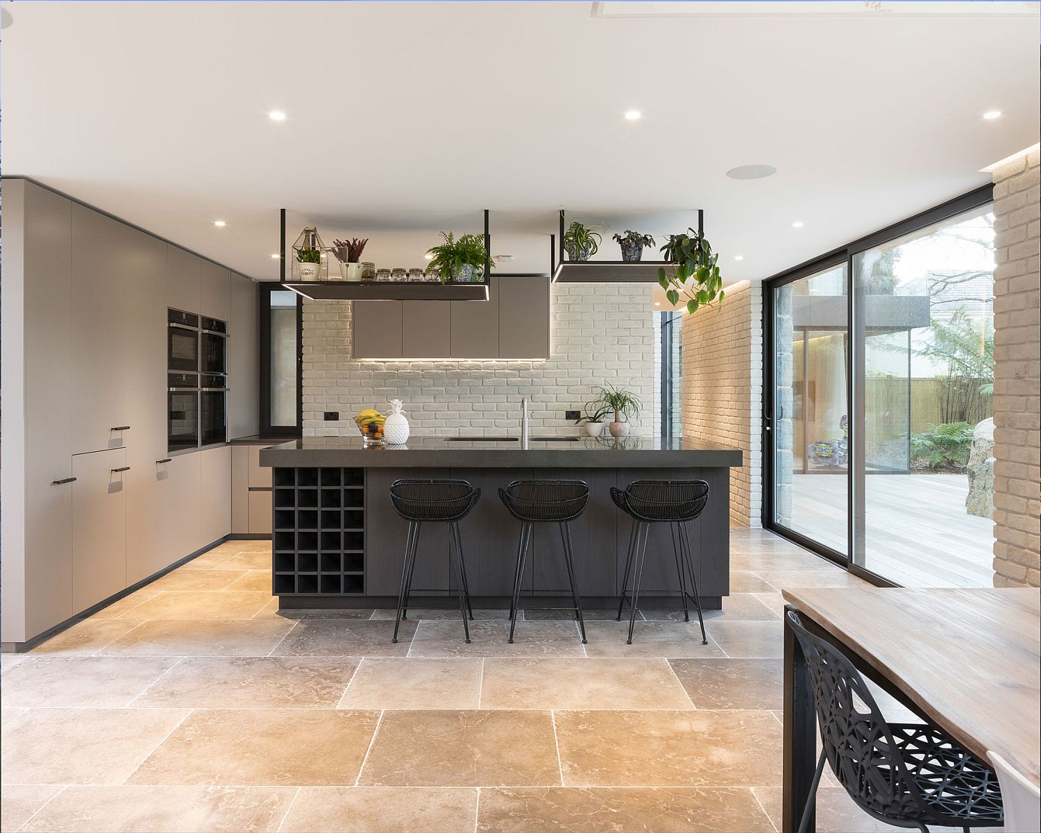 Light-filled kitchen with a dark central island