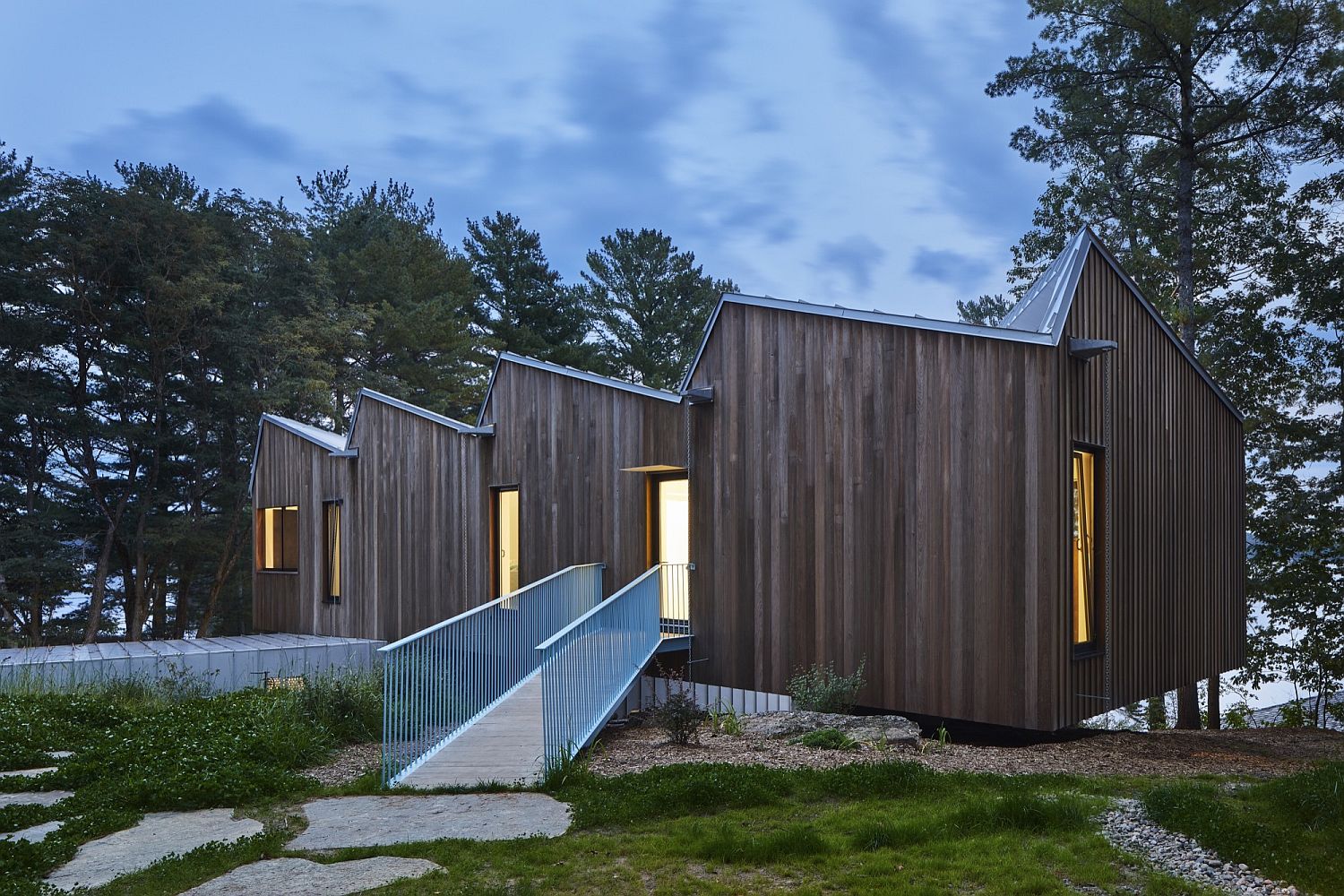 Metallic roof and wooden exterior of lakeside home in Canada