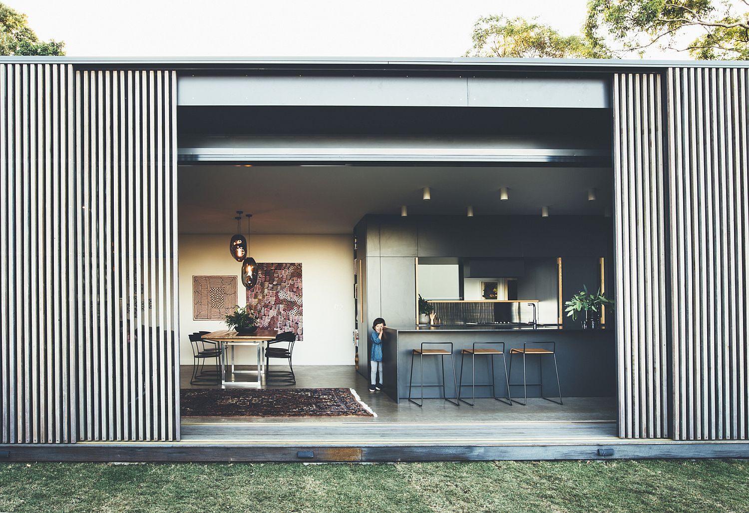 Smart sliding hardwood screens create a flexible living area