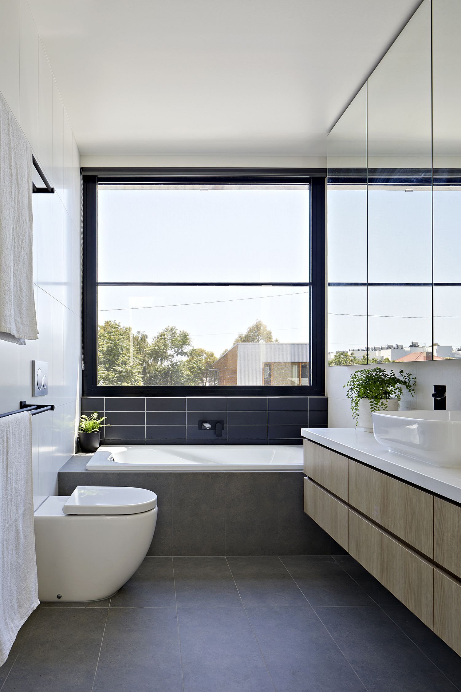 Spacious and elegant contemporary bathroom in gray and white