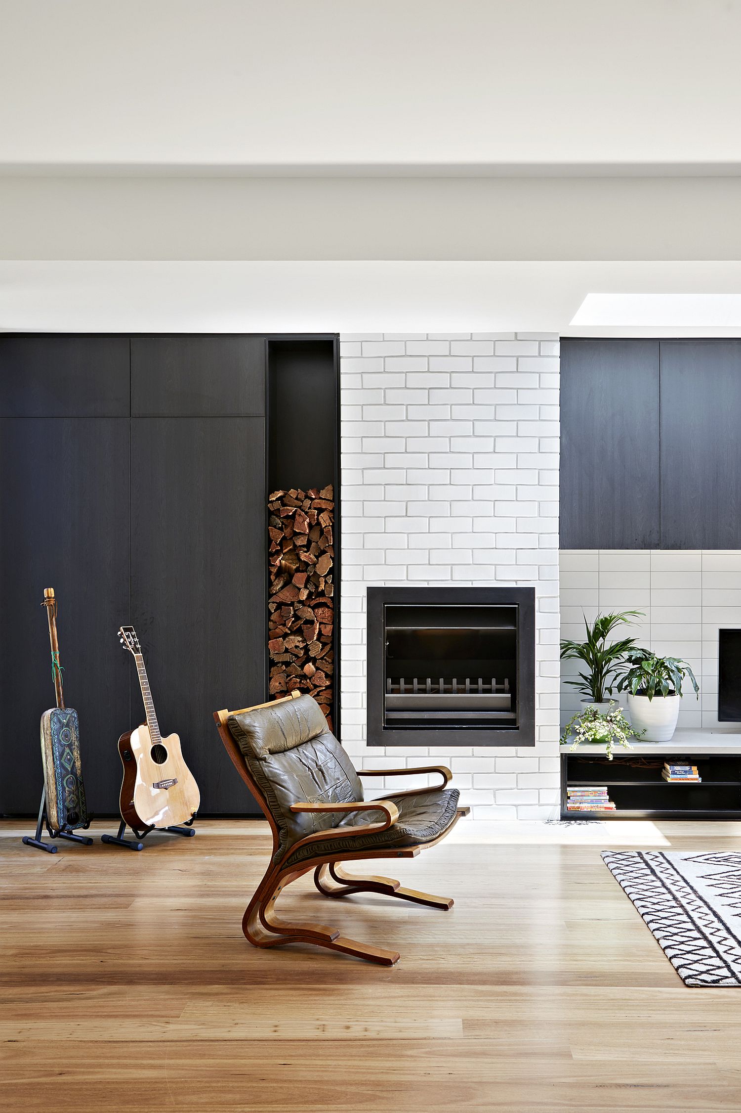 Stacked firewood and brickwall section on the lower level of the house