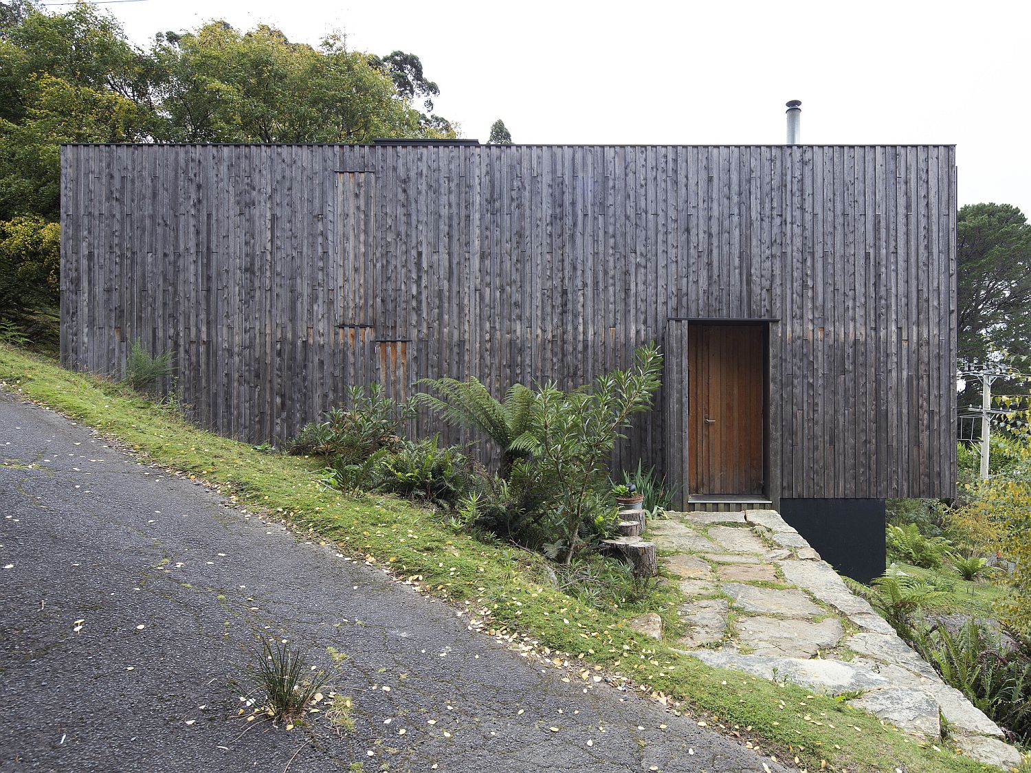 Unfinished timber face of the house gives it a vernacular appeal