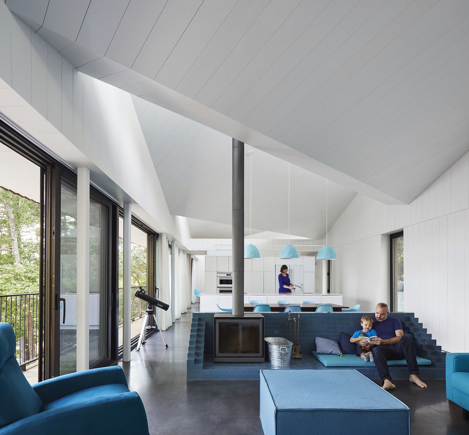 White and blue open plan living space of the lakeside home