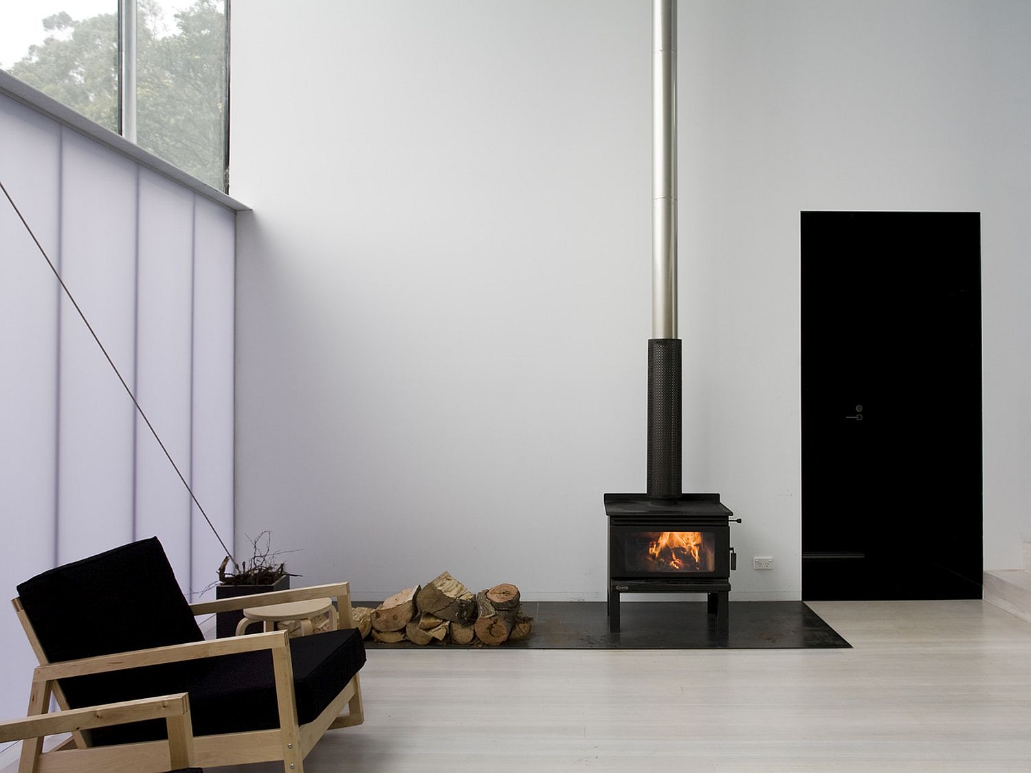 White-and-well-lit-interior-of-the-Hobart-home-surrounded-by-birch-trees