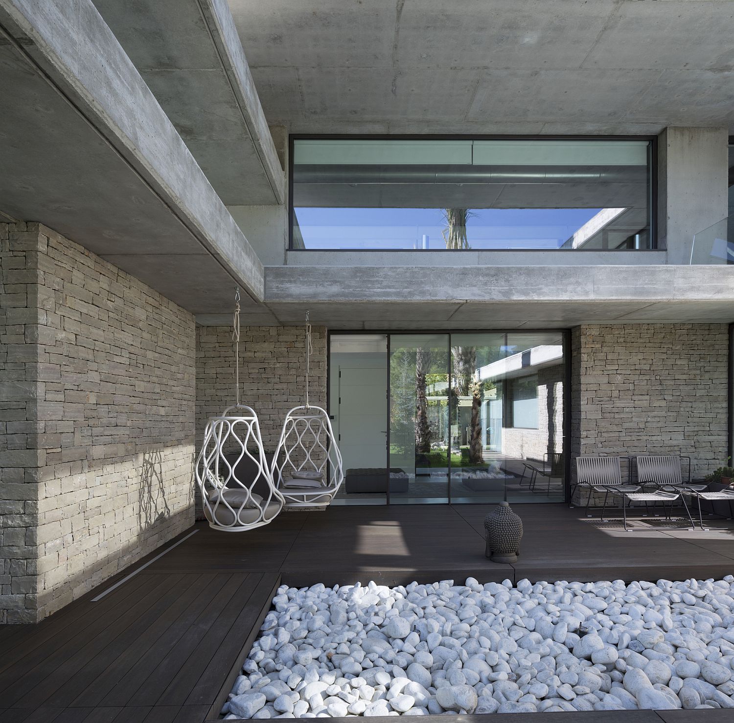 White stones and wooden deck for the courtyard