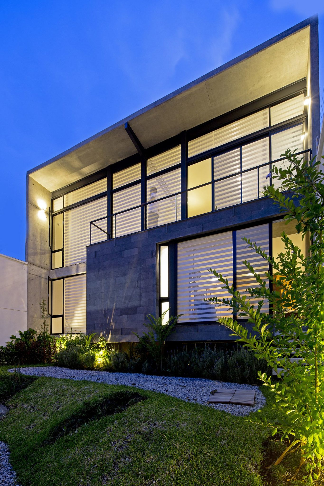 Wood stone, glass and concrete give the home a unique facade