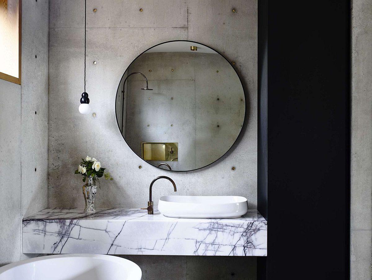 Bathroom with concrete wall and marble vanity