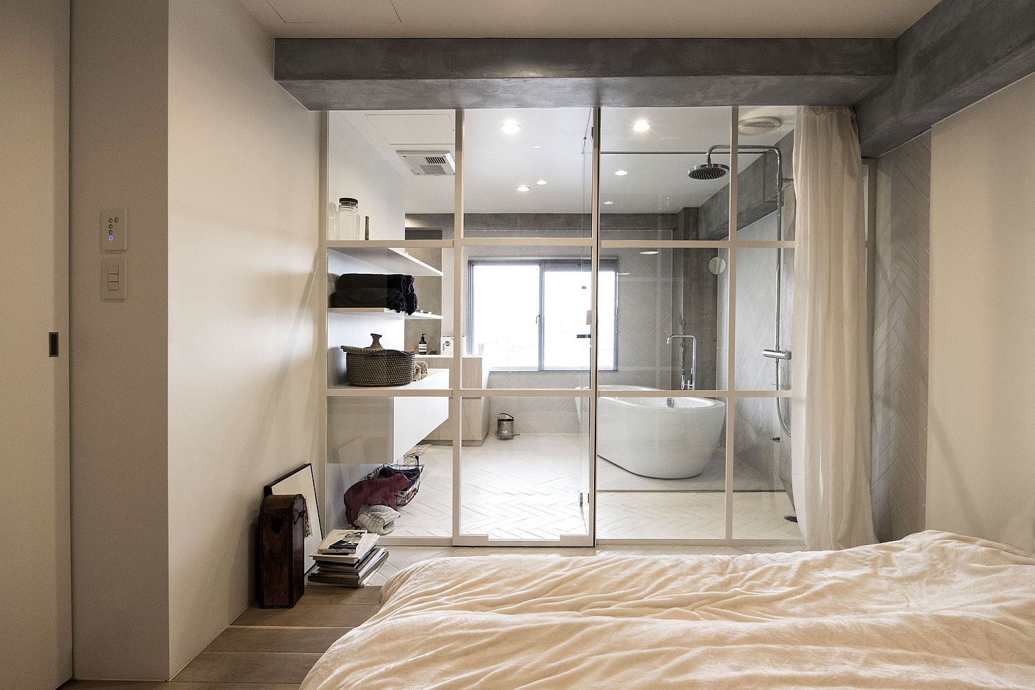 Bedroom-and-bathroom-separated-using-framed-glass-wall