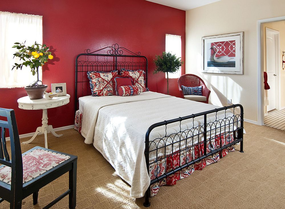 Bright red accent wall for the cottage style bedroom