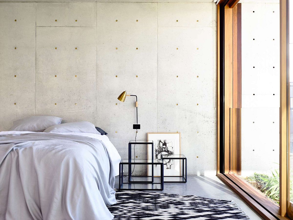 Contemporary bedroom with concrete and glass walls